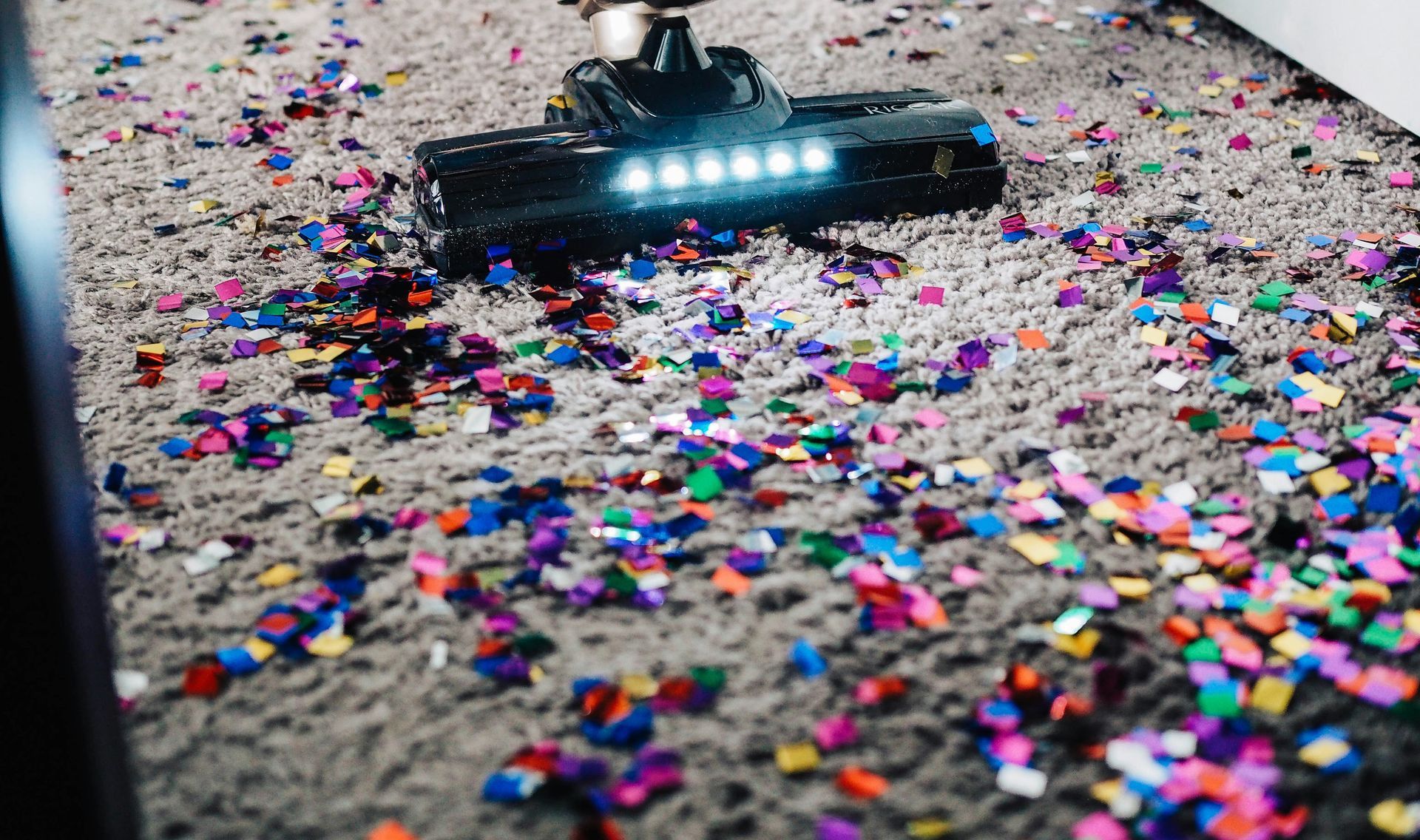 a person using a vacuum to clean a carpet